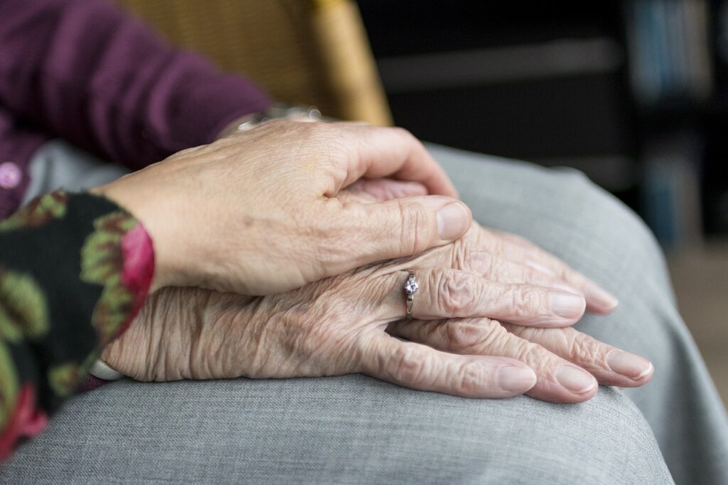 Having Integrity: Why You Must Stand By Your Principals 74 Woman's hand ontop of elderly woman's hand